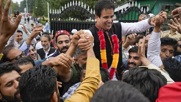 <div class="paragraphs"><p>National Conference candidate Tanvir Sadiq celebrates with supporters after his victory from Zadibal constituency in the Jammu &amp; Kashmir Assembly elections.</p></div>