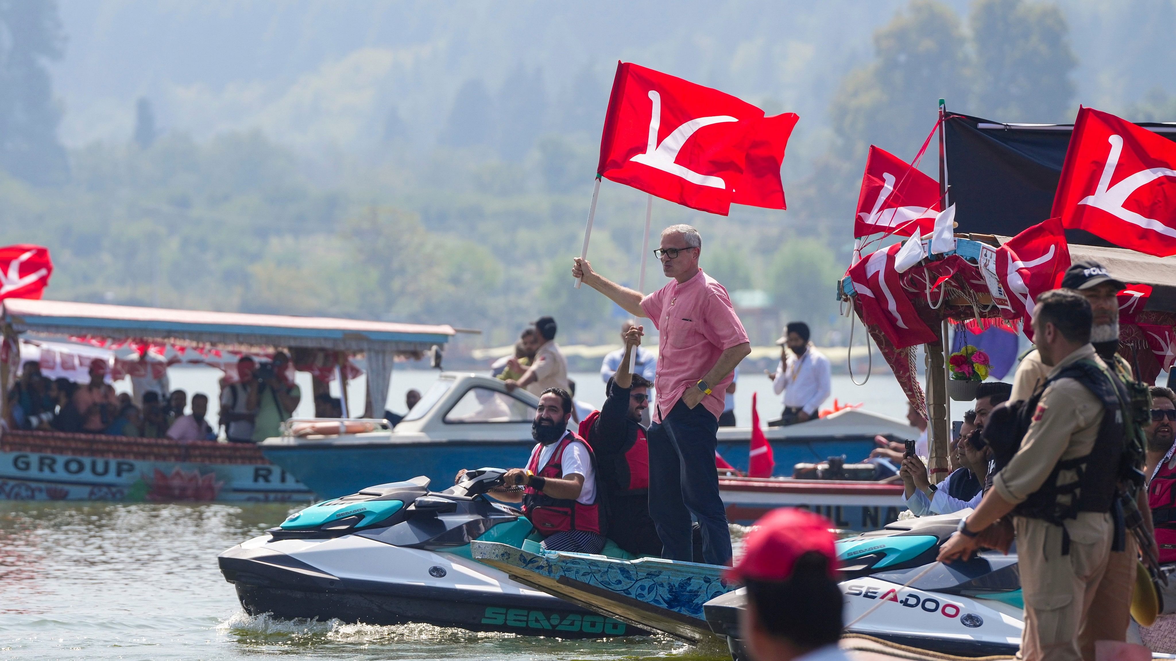 <div class="paragraphs"><p>National Conference Vice President Omar Abdullah holds the party flag.</p></div>