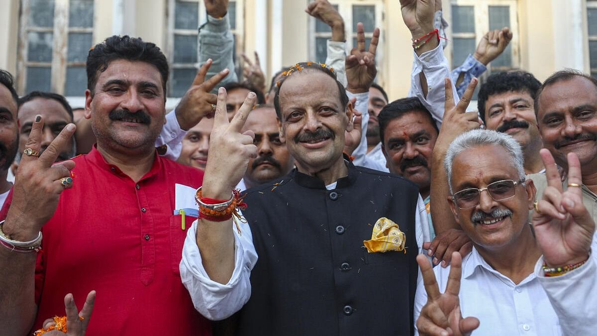 <div class="paragraphs"><p>Devender Singh Rana celebrates with supporters after his win from Nagrota.&nbsp;</p></div>