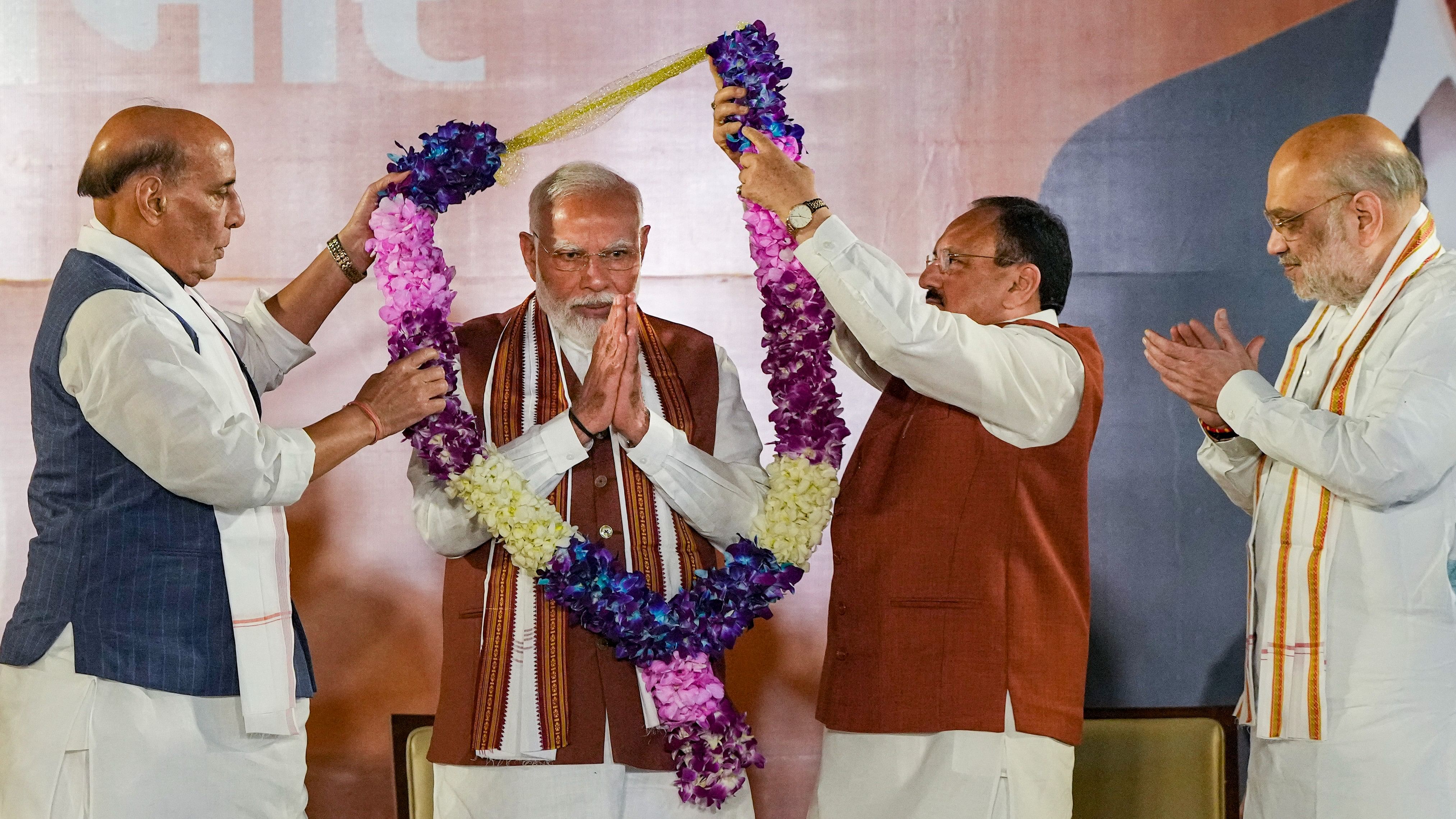 <div class="paragraphs"><p>Prime Minister Narendra Modi being felicitated by Union Home Minister Amit Shah, Union Defence Minister Rajnath Singh and Union Minister and BJP National President JP Nadda</p></div>