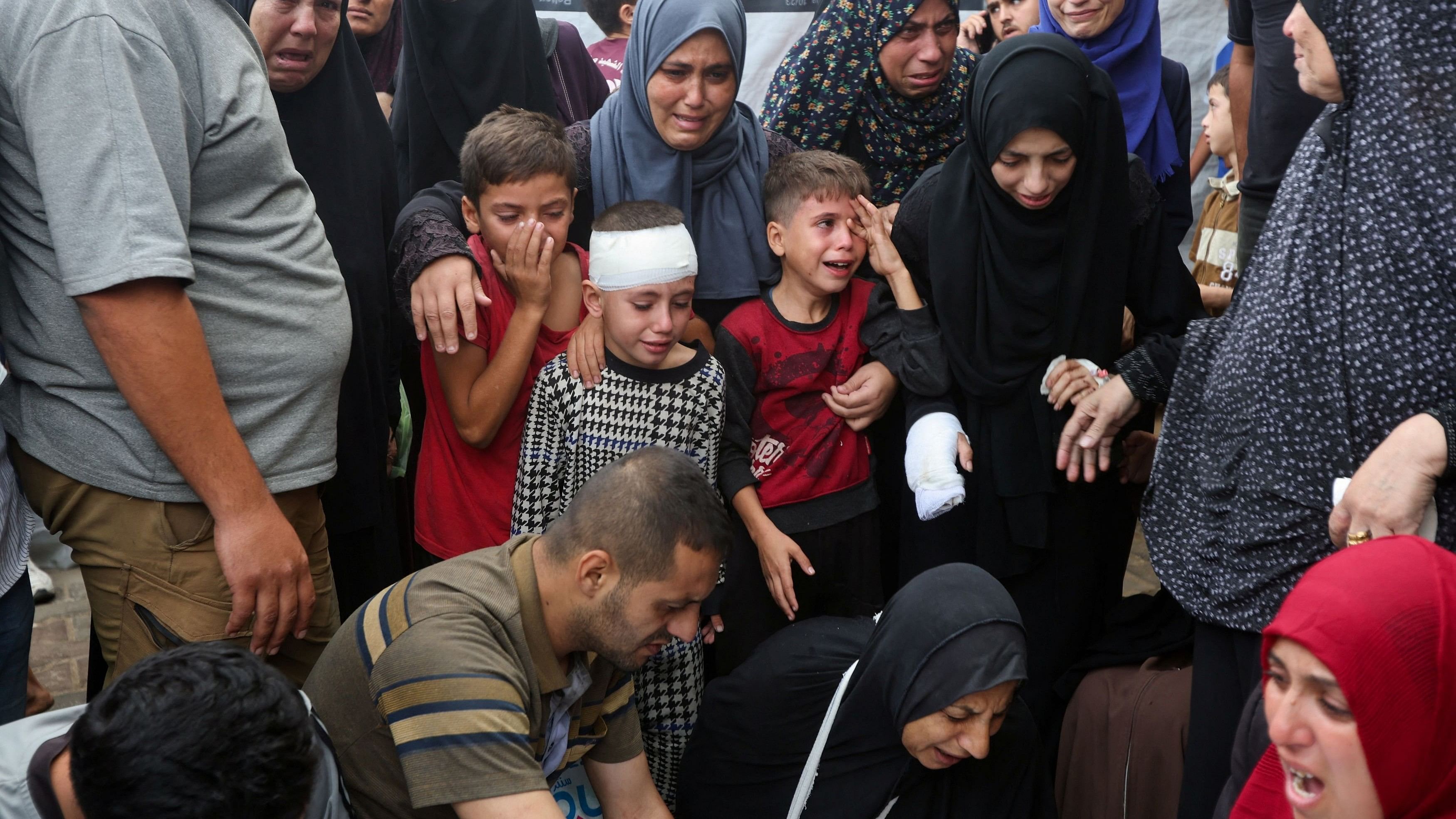 <div class="paragraphs"><p>Children react next to the bodies of Palestinians, who were killed in Israeli strikes, amid the Israel-Hamas conflict, at Al-Aqsa Martyrs Hospital in Deir Al-Balah in the central Gaza Strip, October 8, 2024. </p></div>