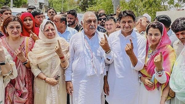 <div class="paragraphs"><p>Congress leaders Bhupinder Singh Hooda and Deepender Singh Hooda after casting their votes at a polling booth during the sixth phase of Lok Sabha elections.</p></div>