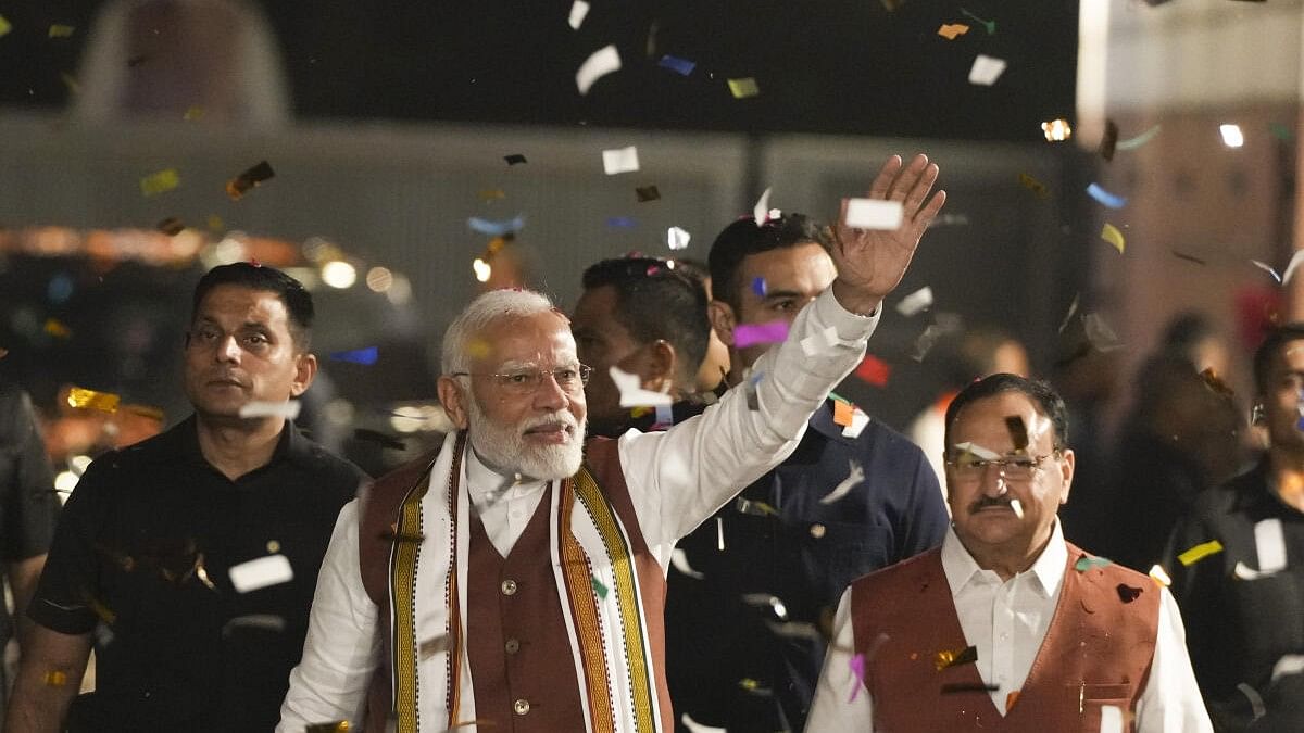 <div class="paragraphs"><p>Prime Minister Narendra Modi greets the gathering upon his arrival at the party headquarters in Delhi.</p></div>