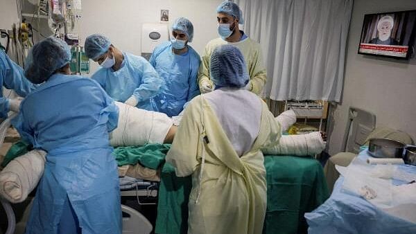 <div class="paragraphs"><p>Medical staff attend to a patient, casualty of an airstrike, in the ICU of Geitaoui Hospital burns unit as Lebanon's Hezbollah deputy leader Sheikh Naim Qassem delivers a speech on TV, in Beirut, Lebanon, October 8, 2024.</p></div>