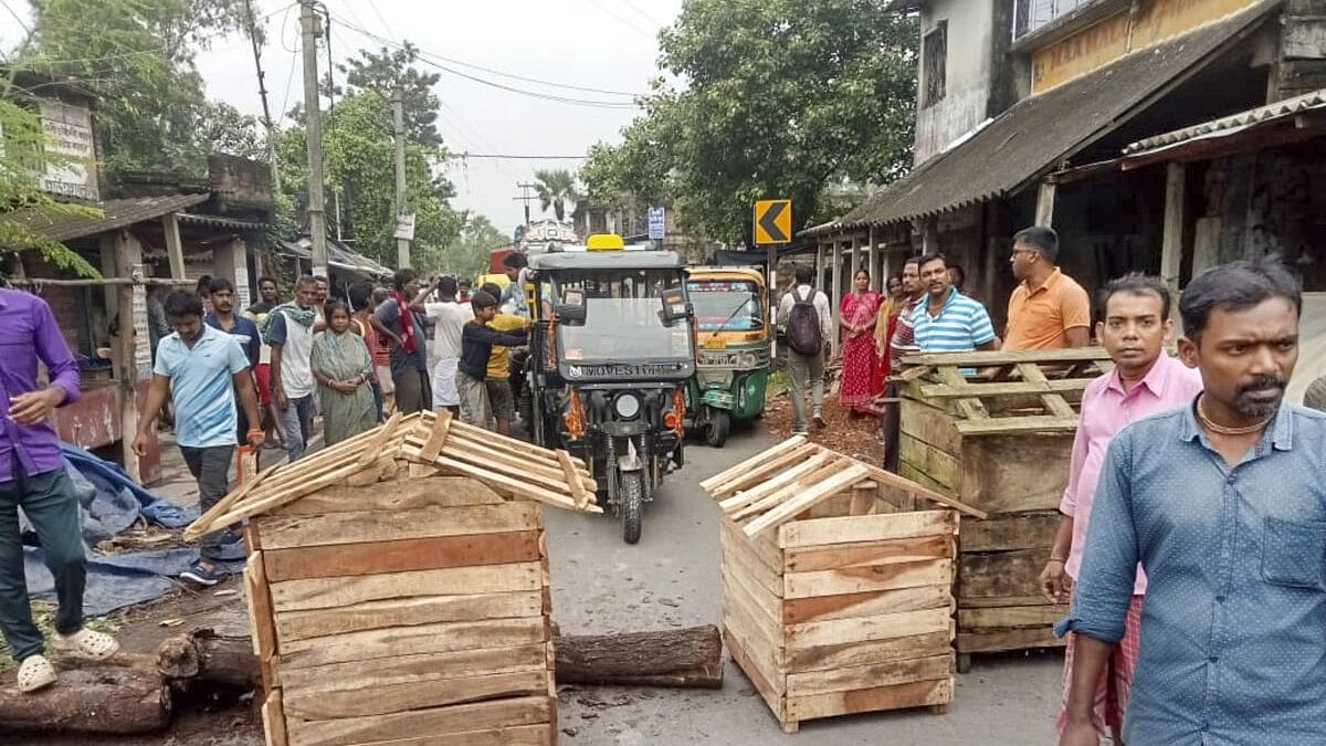 <div class="paragraphs"><p>Irate villagers block a road as they stage a protest after an incident of alleged rape and murder of a young village girl in Kultali area of South 24 Parganas district.</p></div>