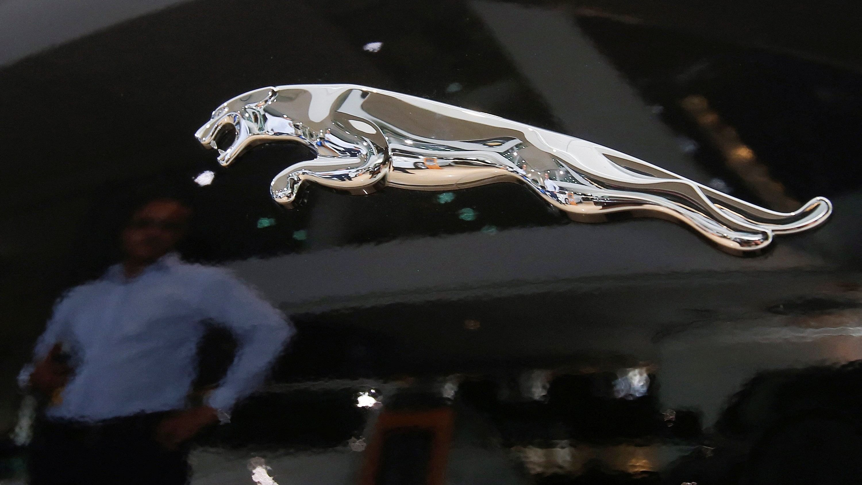 <div class="paragraphs"><p>A man is reflected in the logo of a Jaguar vehicle at a Jaguar Land Rover showroom in Mumbai</p></div>