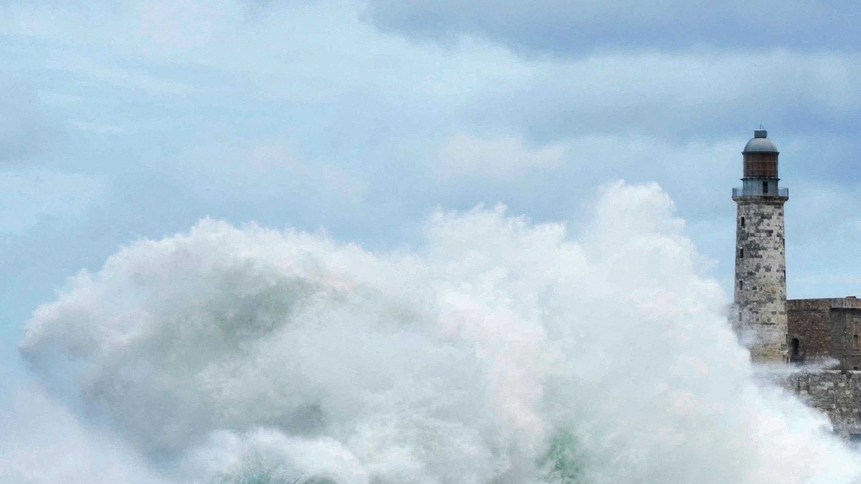 <div class="paragraphs"><p>Waves crash over Havana's seafront boulevard El Malecon near a lighthouse as Hurricane Milton passes close to the Cuban coast, Havana, Cuba, October 9, 2024. </p></div>