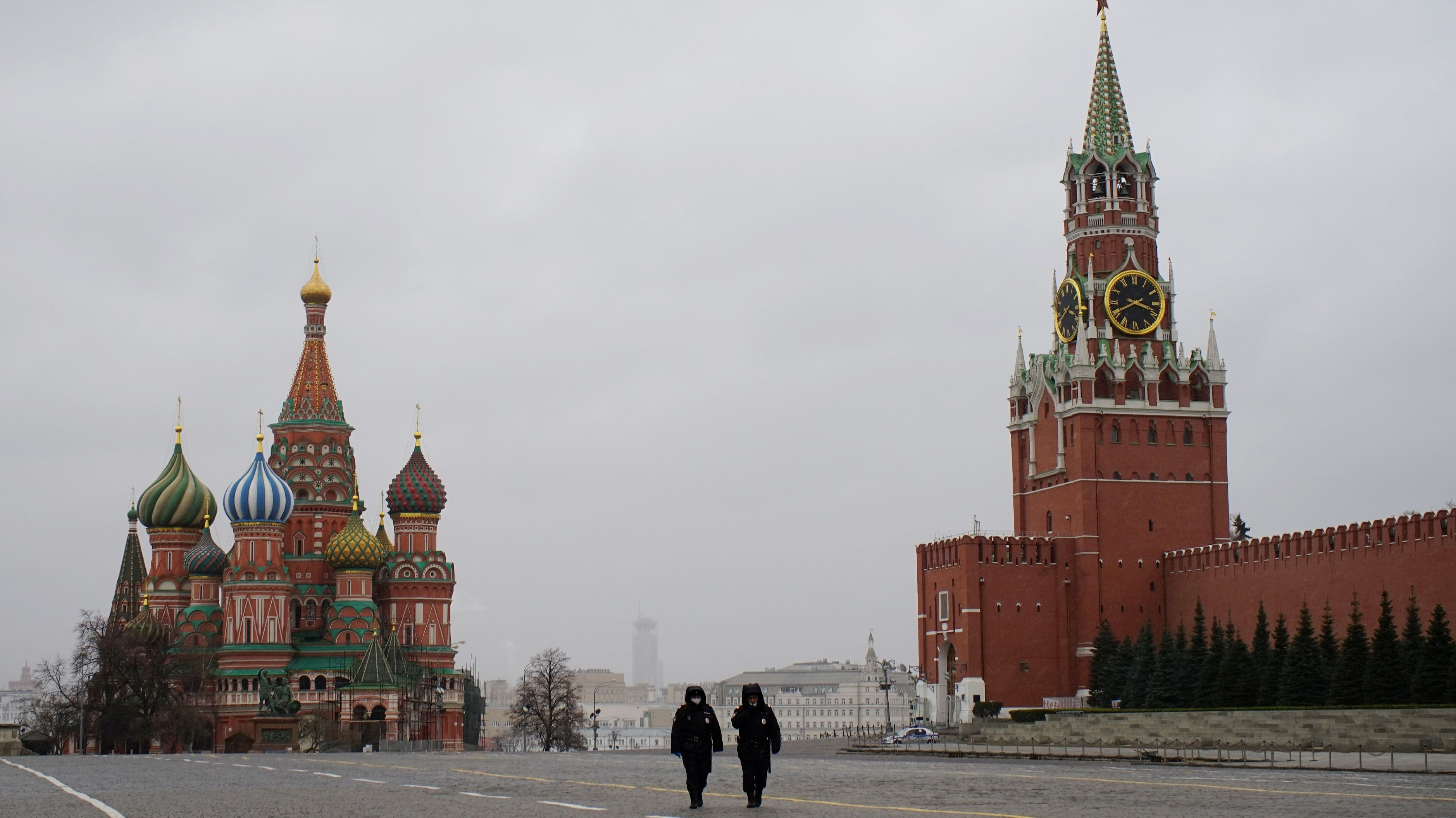 <div class="paragraphs"><p>Police officers walk along the Red Square, with St. Basil's Cathedral and the Kremlin's Spasskaya Tower in the background.</p></div>