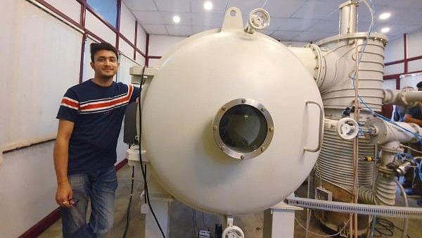 <div class="paragraphs"><p>Bellatrix Aerospace CEO Rohan Ganapathy stands next to a vacuum chamber at their laboratory in Bengaluru.</p></div>