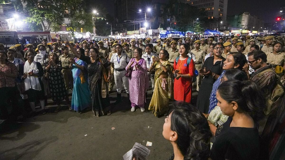 <div class="paragraphs"><p>People raise slogans in solidarity with junior doctors protesting against the alleged rape and murder of a woman medic at the RG Kar Medical Collage and Hospital, in Kolkata, Wednesday, October 9, 2024.</p></div>