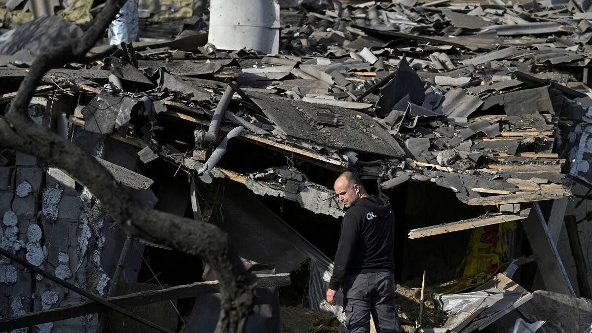 <div class="paragraphs"><p>A man stands next to his house destroyed by a Russian air strike, amid Russia's attack on Ukraine, in Zaporizhzhia, Ukraine.</p></div>