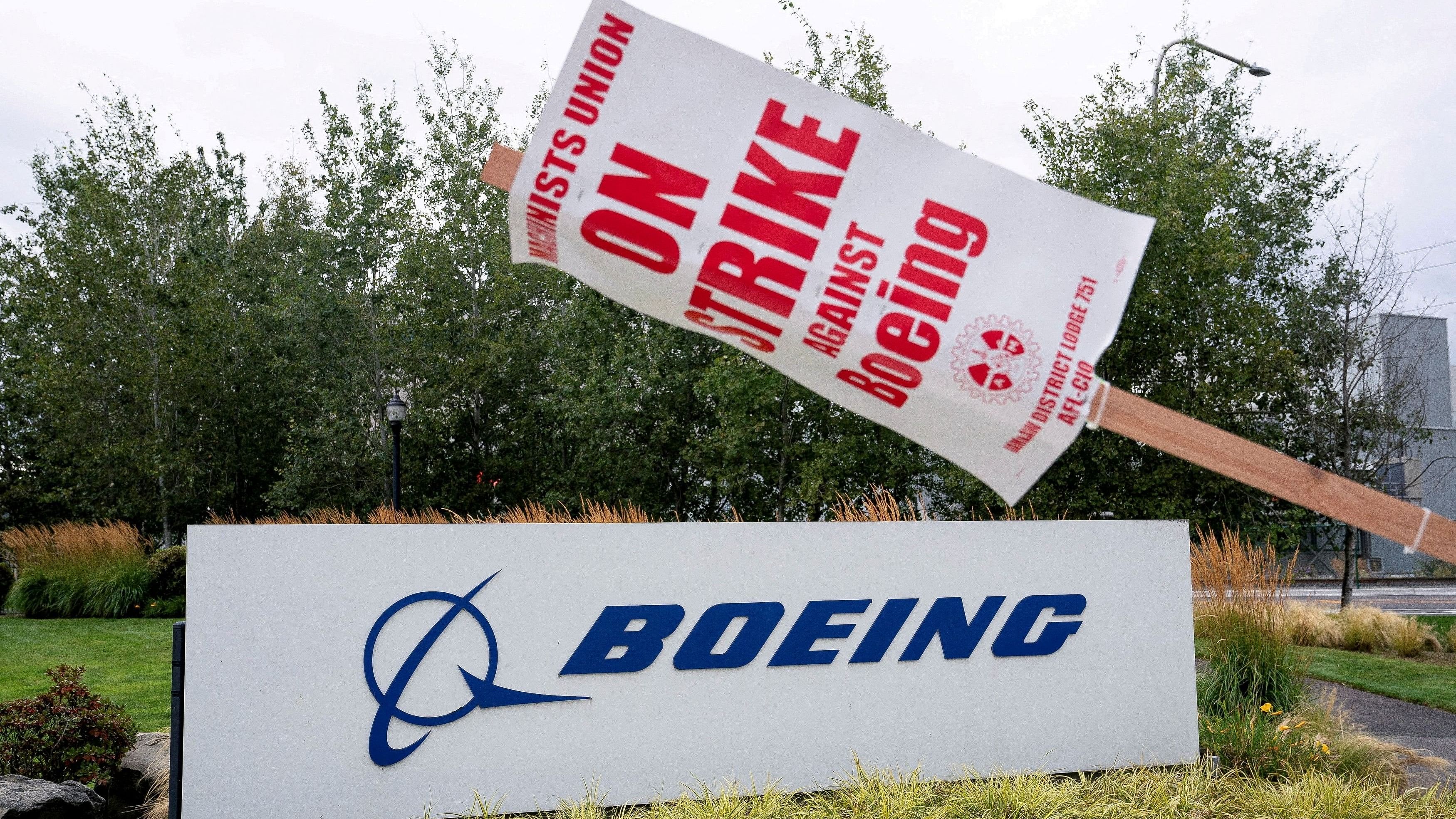 <div class="paragraphs"><p>A strike sign hangs from a post near a Boeing sign.</p></div>