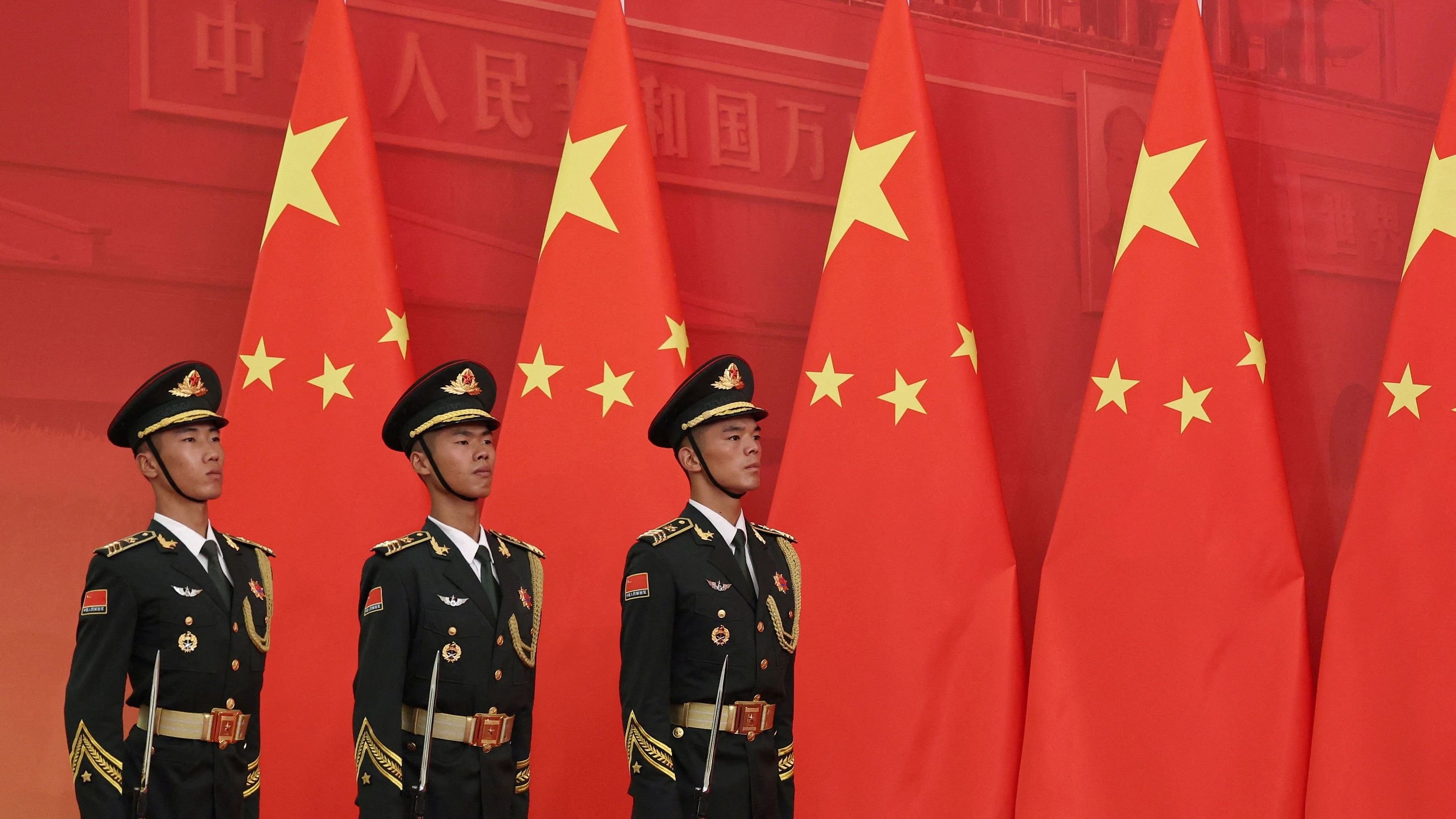 <div class="paragraphs"><p>File Photo: Honour guard members stand in formation in front of Chinese flags before a presentation ceremony of national medals and honorary titles, at the Great Hall of the People ahead of the 75th founding anniversary of the People's Republic of China, in Beijing, China.</p></div>