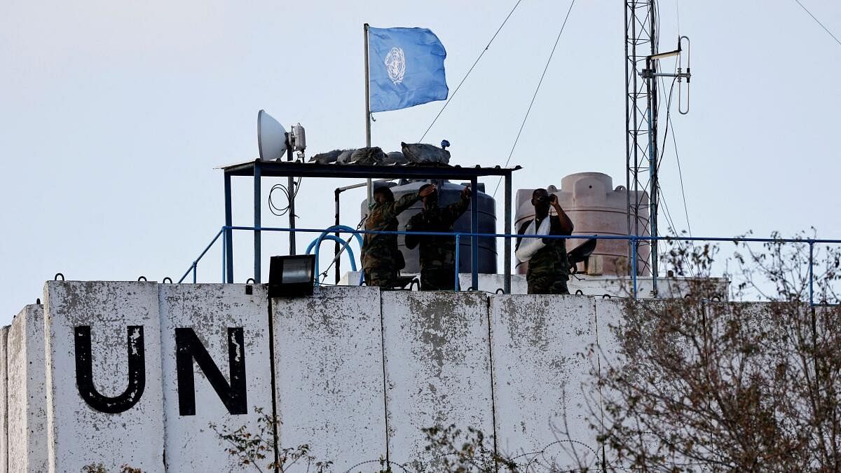 <div class="paragraphs"><p> Members of the United Nations peacekeepers (UNIFIL) look at the Lebanese-Israeli border, as they stand on the roof of a watch tower ‏in the town of Marwahin, in southern Lebanon,</p></div>