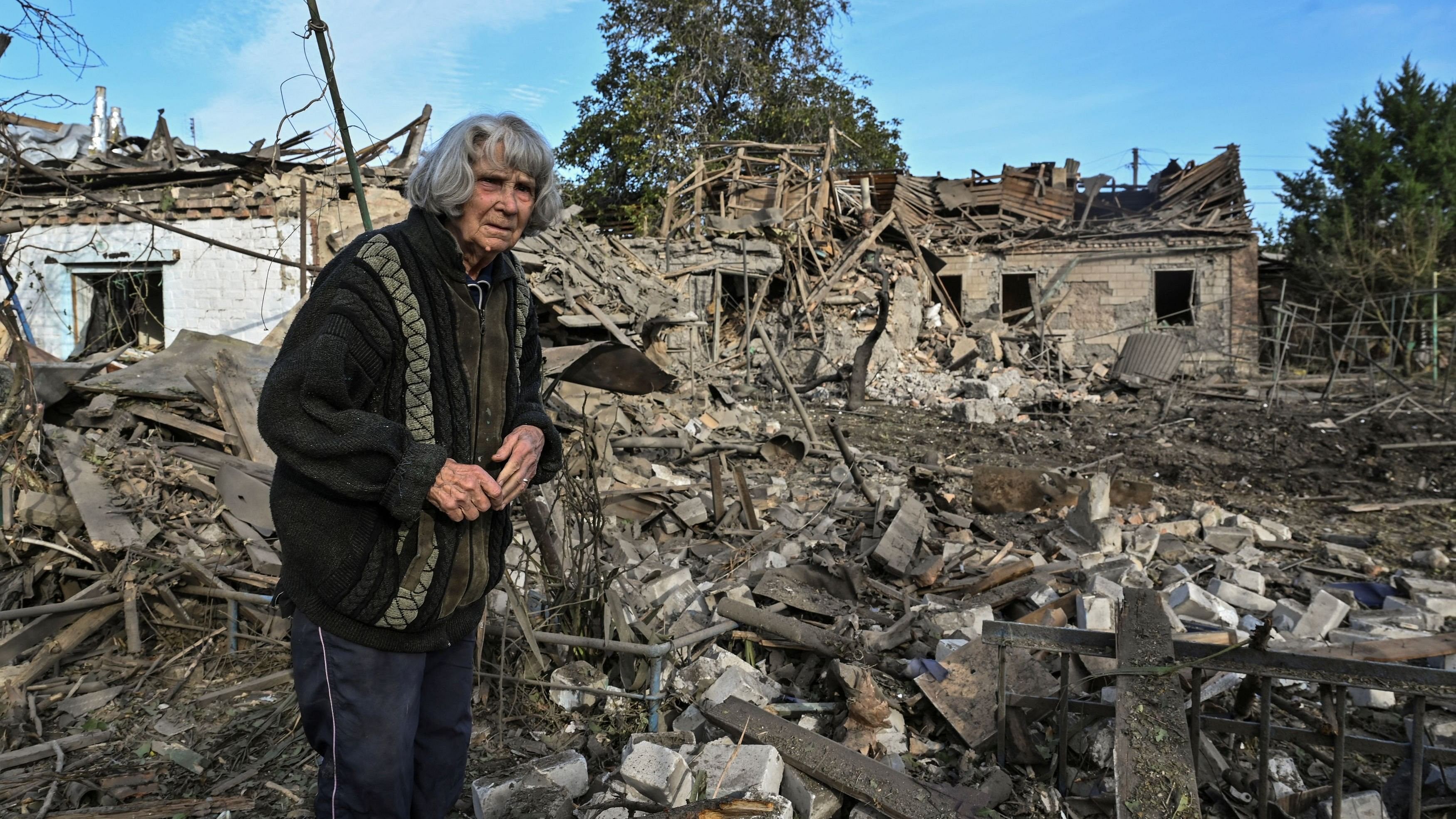 <div class="paragraphs"><p>A woman stands in the backyard of her house destroyed by a Russian air strike, amid Russia's attack on Ukraine, in Ukraine.</p></div>