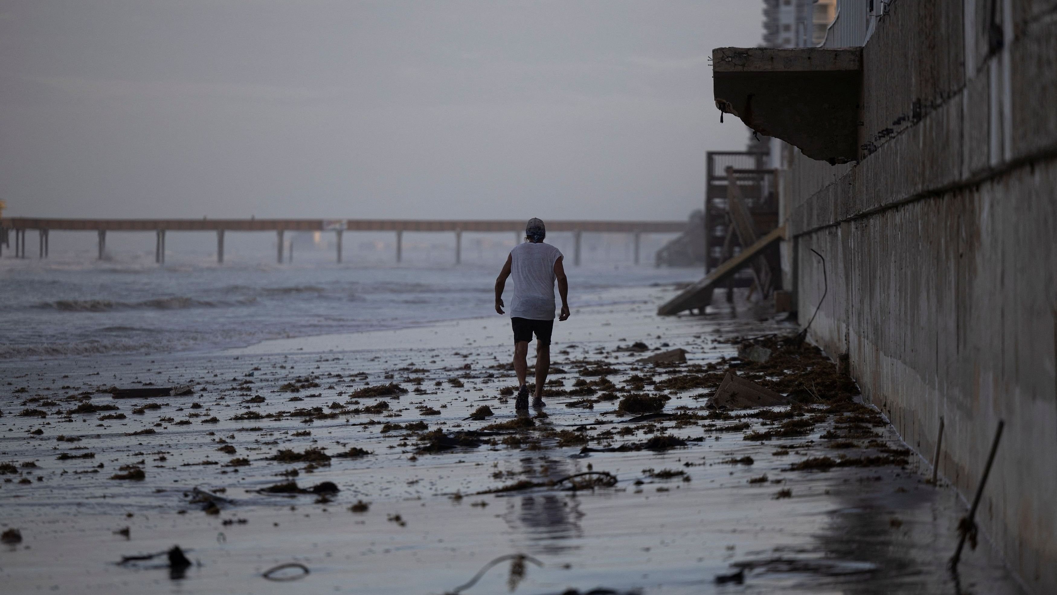 <div class="paragraphs"><p>A man walks on the beach after Hurricane Milton made landfall in South Daytona, Florida, US.</p></div>