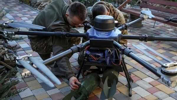 <div class="paragraphs"><p>Servicemen of the 15th Operative Purpose Brigade 'Kara-Dag' of the National Guard of Ukraine attach explosive devices to a Kazhan combat drone before flying over positions of Russian troops, amid Russia's attack on Ukraine, near the town of Pokrovsk in Donetsk region.&nbsp;</p></div>