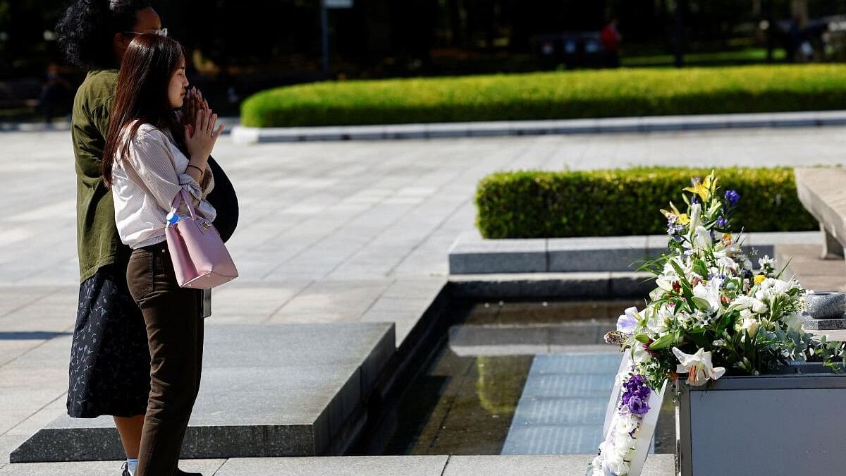 <div class="paragraphs"><p>Visitors pray in front of the Cenotaph for the victims of the 1945 atomic bombing at the Hiroshima Peace Memorial Park, on the following day of The Japan Confederation of A- and H-Bomb Sufferers Organizations (Nihon Hidankyo) winning the 2024 Nobel Peace Prize, in Hiroshima, western Japan, October 12, 2024.</p></div>