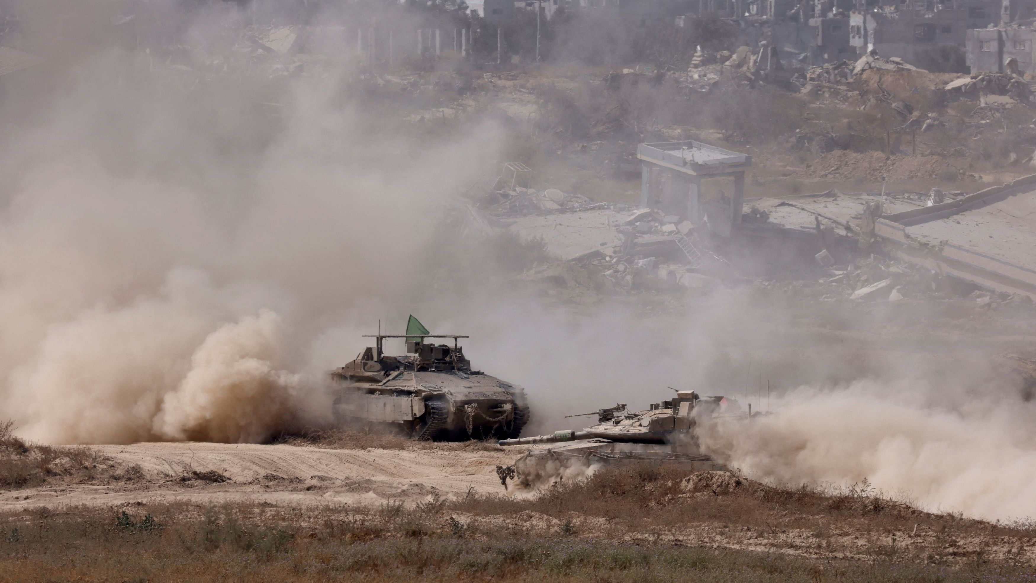 <div class="paragraphs"><p>An Israeli tank and an APC manuever in the Gaza Strip.</p></div>