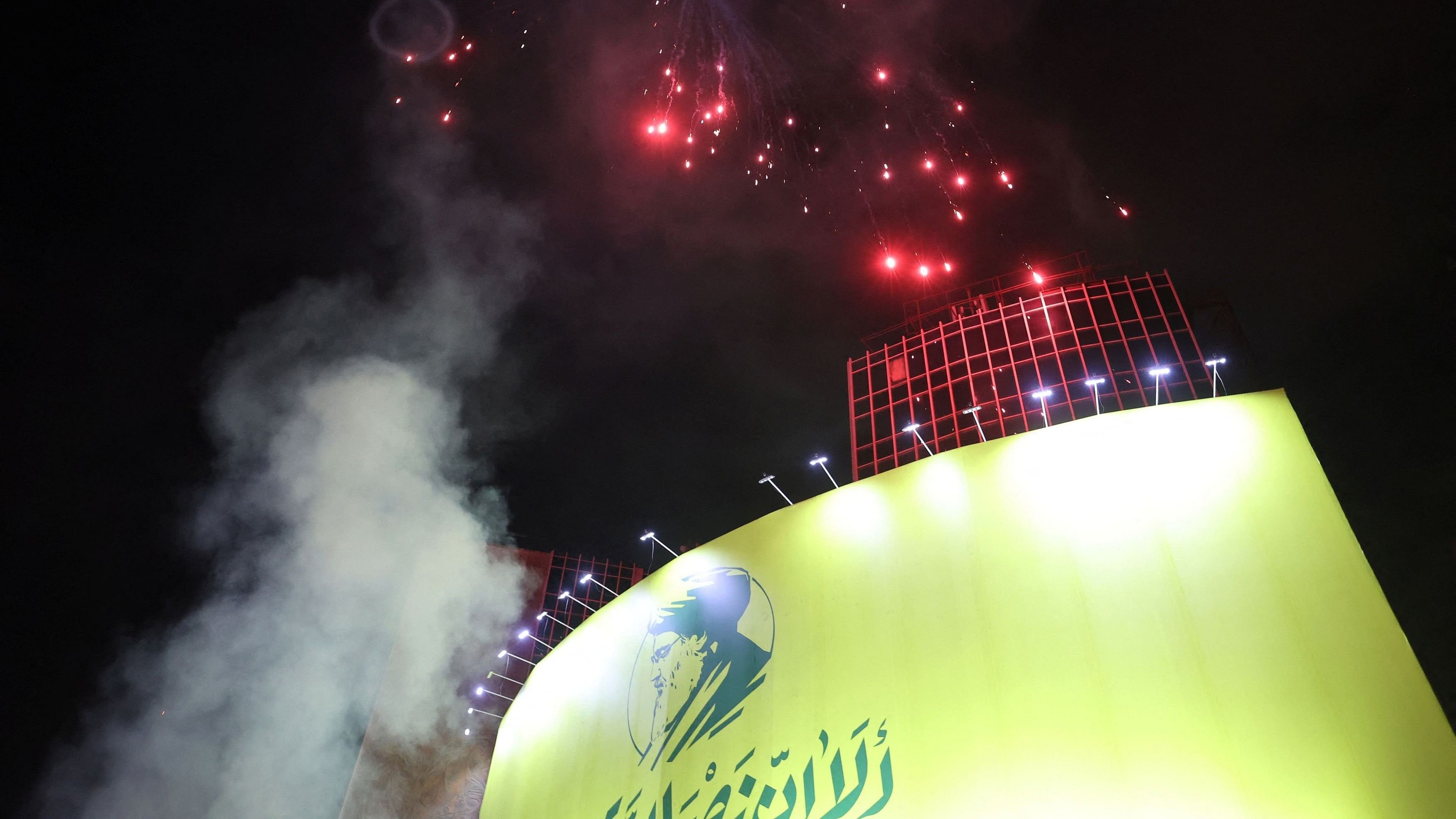 <div class="paragraphs"><p>Iranians light fireworks next to a billboard with a picture of the late Lebanon's Hezbollah leader Sayyed Hassan&nbsp;Nasrallah, after the IRGC attack on Israel, in Tehran, Iran.</p></div>