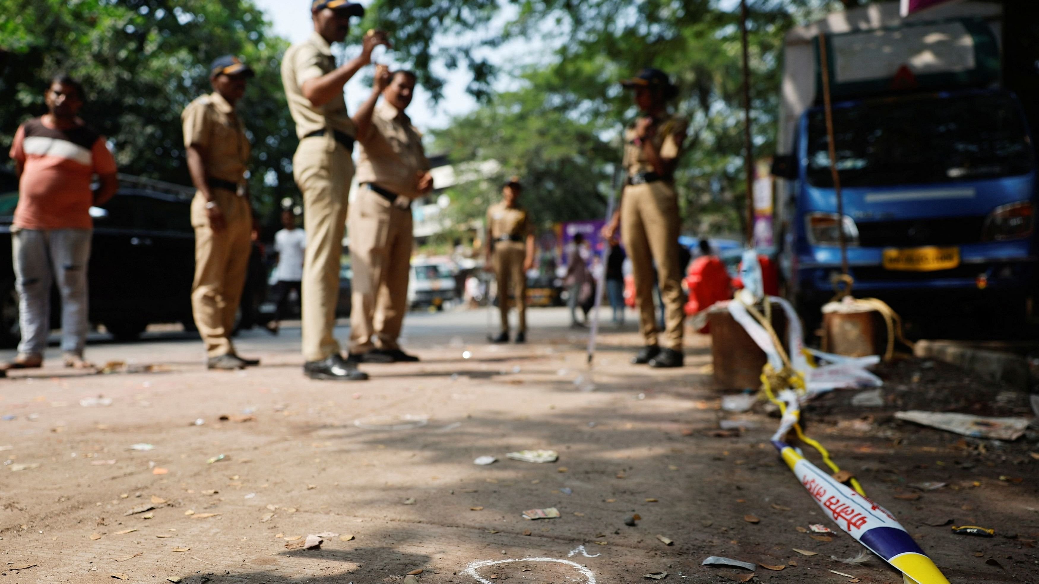 <div class="paragraphs"><p>Police officers stand at the crime scene next to markings of the gunshots where Nationalist Congress Party  politician Baba Siddique was shot dead in Mumbai, October 13, 2024. </p></div>