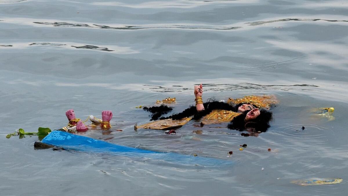 <div class="paragraphs"><p>An idol of Goddess Durga floats in the Ganga after immersion.</p></div>