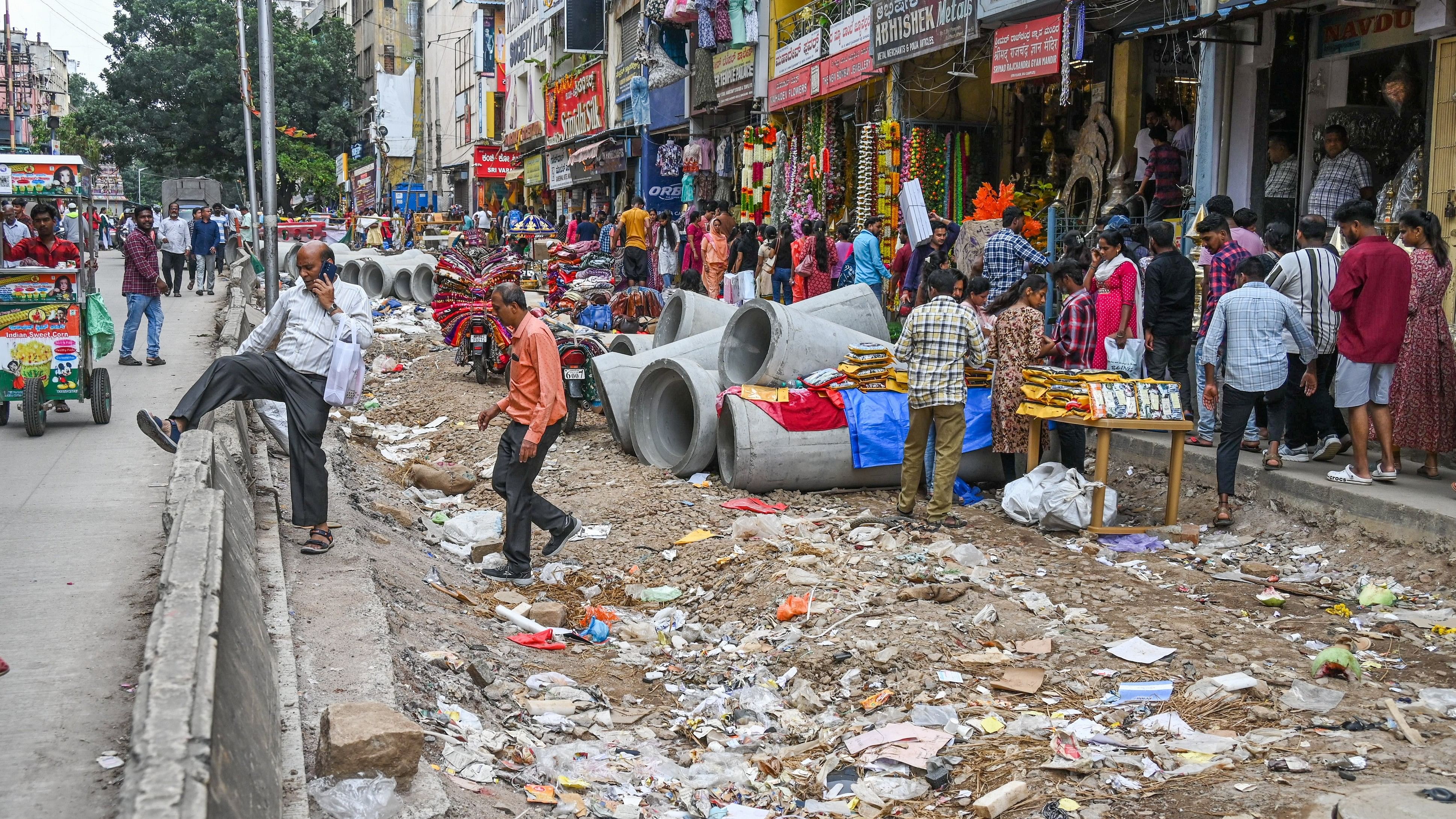 <div class="paragraphs"><p>Salesmen at BVK Iyengar Road say street vendors have taken advantage of the idle construction site. The unfinished road has provided them space to set up stalls, they say. </p></div>