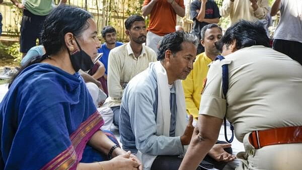 <div class="paragraphs"><p>A policeman speaks with climate activist Sonam Wangchuk staging a protest demanding the inclusion of Ladakh in the Sixth Schedule of the Indian constitution, at the Ladakh Bhawan, in New Delhi,.&nbsp;</p></div>