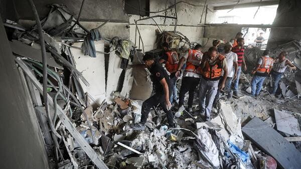 <div class="paragraphs"><p>Palestinians inspect the damage inside the al-Remal clinic, which had been sheltering displaced people, after it was struck by an Israeli airstrike during the ongoing Israel-Hamas conflict in Gaza City.</p></div>