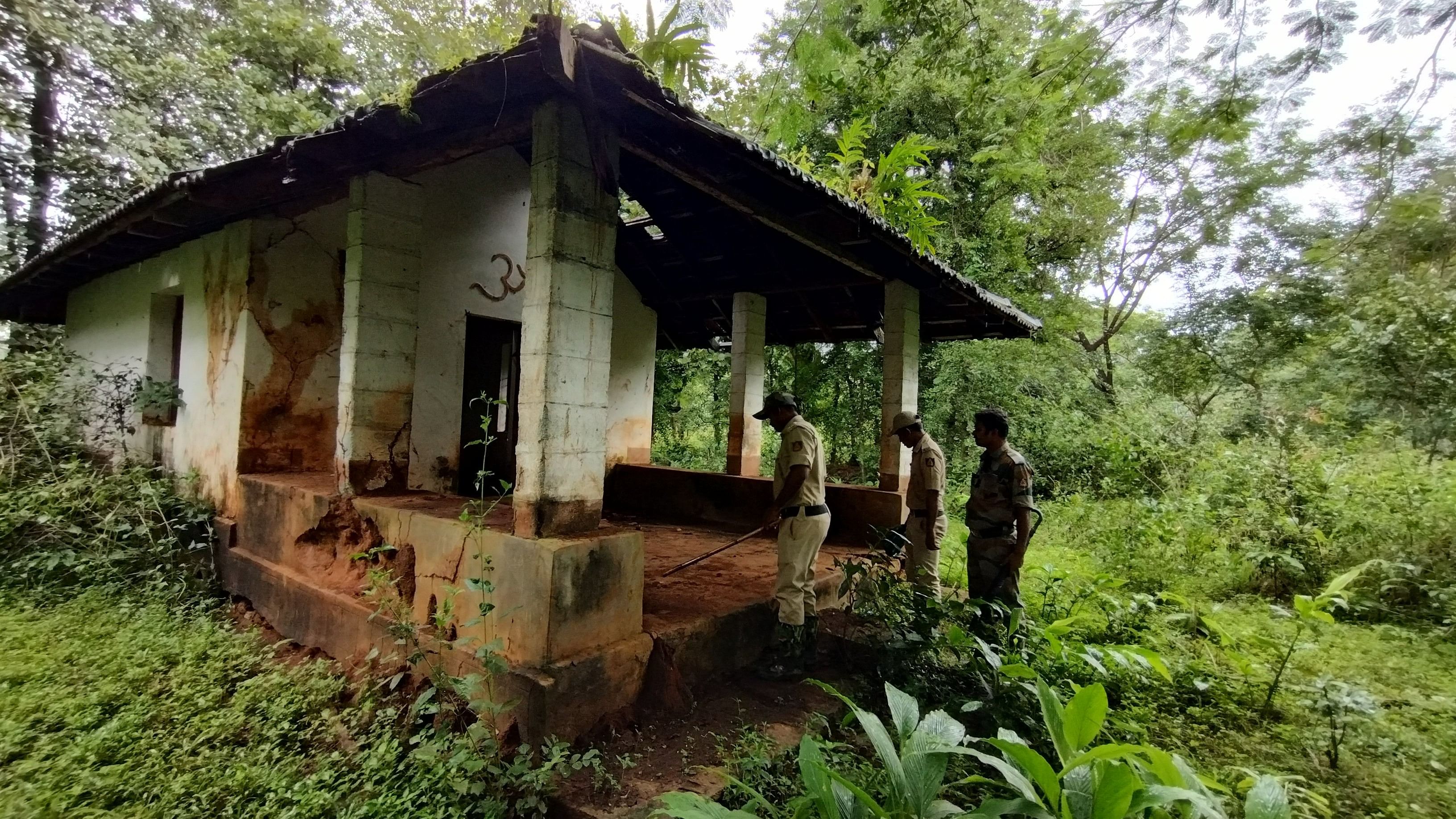 <div class="paragraphs"><p>Forest officials outside the Madhukeshwar temple, the only structure that has been left undemolished, inside the Bhadra Tiger Reserve. </p></div>