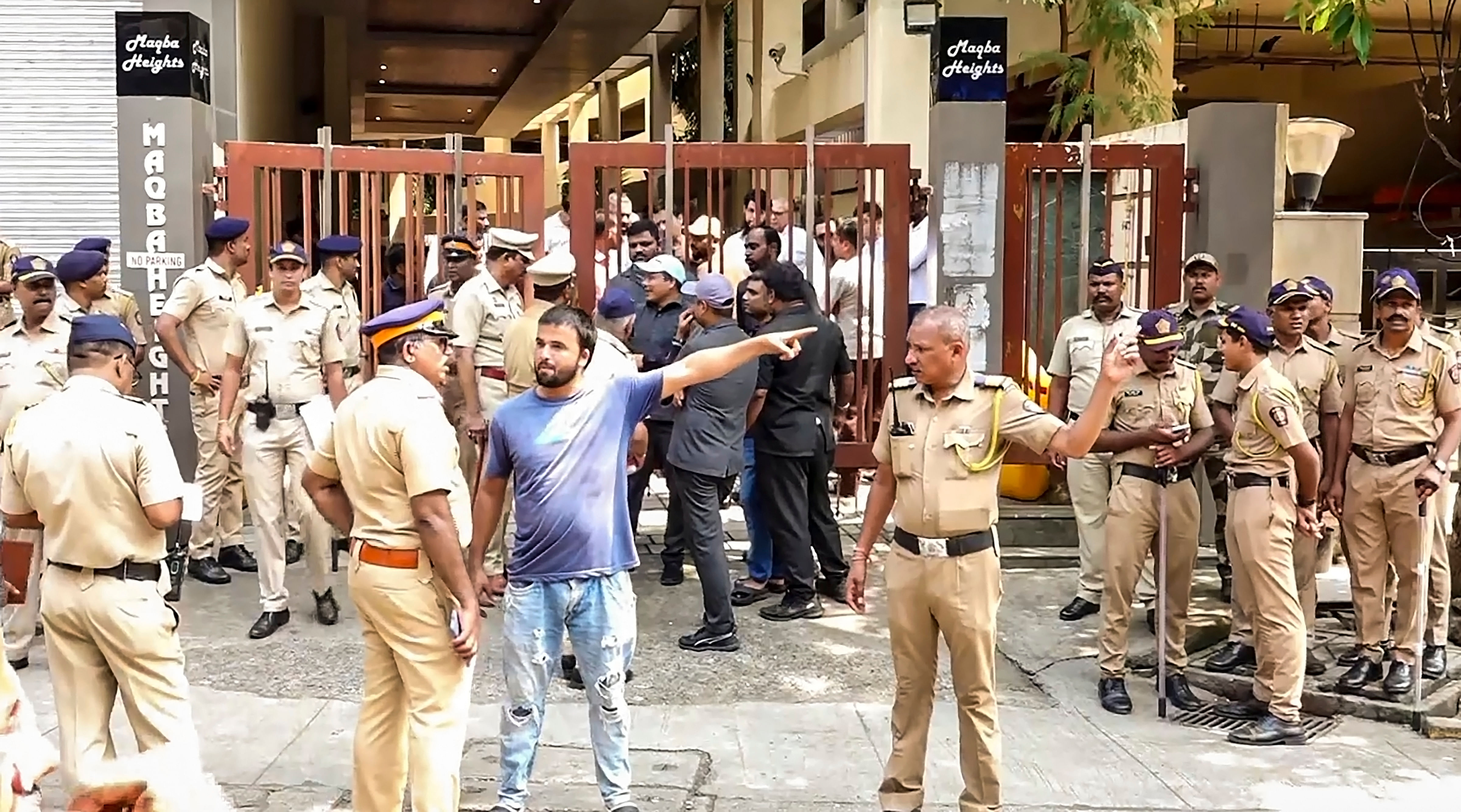 <div class="paragraphs"><p>Police personnel gather outside the residence of NCP leader Baba Siddique where his body being brought, in Mumbai, Sunday, Oct. 13, 2024. Siddique was shot dead on Saturday. </p></div>