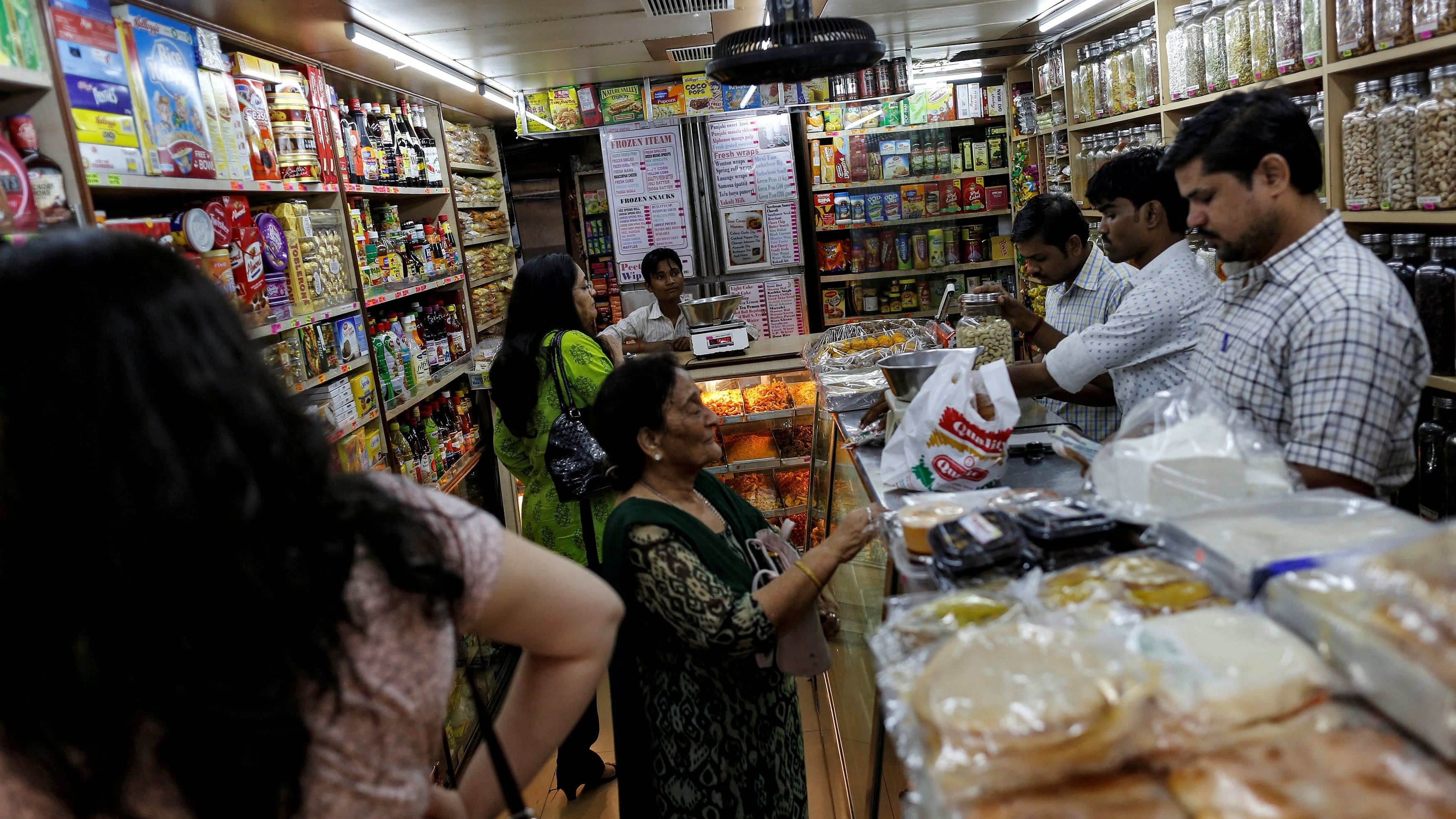 <div class="paragraphs"><p>FILE PHOTO: People shop inside a grocery store at a residential area in Mumbai, India June 13, 2016. </p></div>