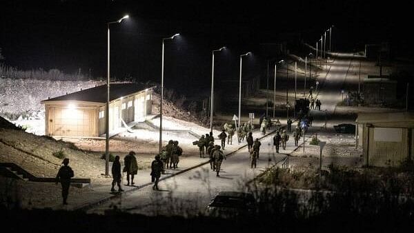 <div class="paragraphs"><p>Israeli soldiers walk near the scene where a drone from Lebanon attacked Israel, amid cross-border hostilities between Hezbollah and Israel, in Binyamina Israel.&nbsp;</p></div>