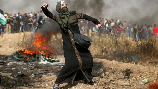 <div class="paragraphs"><p>A Palestinian girl hurls stones at Israeli troops, east of Gaza City.</p></div>