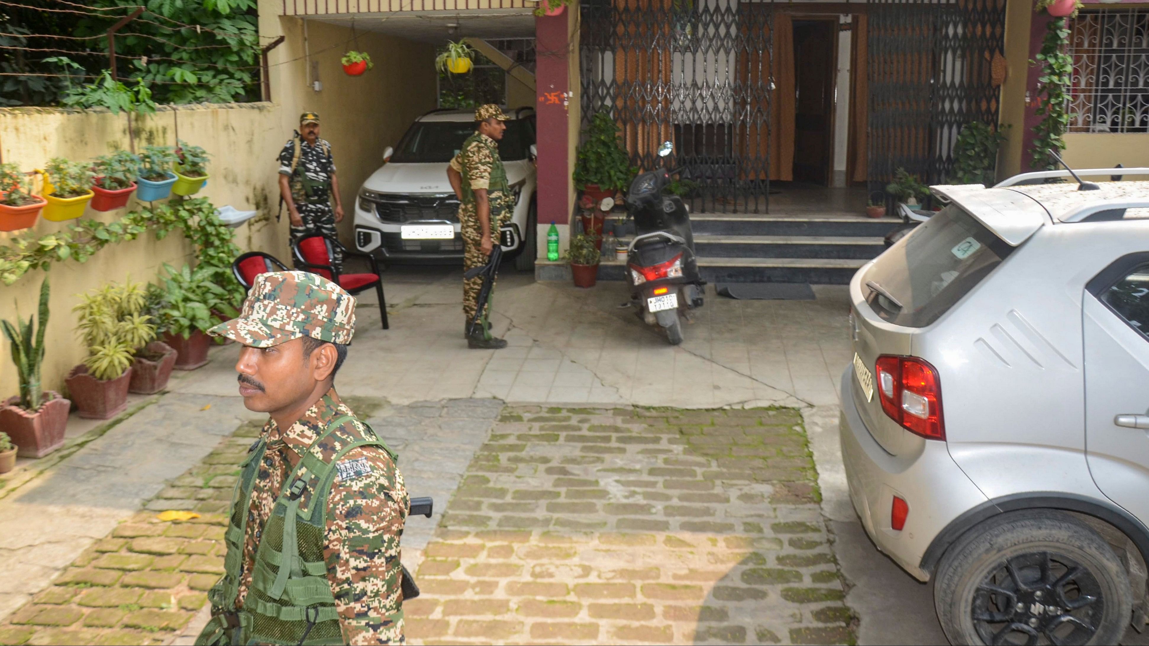 <div class="paragraphs"><p>CRPF personnel stand outside the residence of Manish Ranjan, close aide of Jharkhand Minister Mithilesh Thakur, as the ED conducts raids in the connection with the alleged rural development scam, in Ranchi, Monday, Oct. 14, 2024.</p></div>