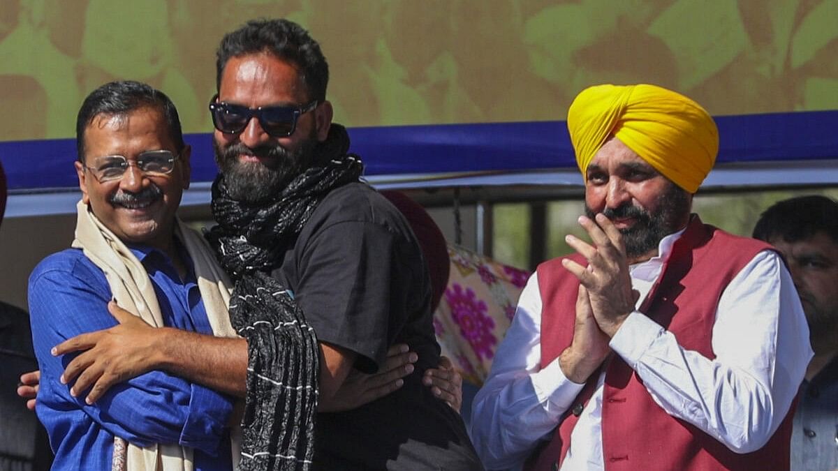 <div class="paragraphs"><p>Mehraj Malik, flanked by AAP national convener Arvind Kejriwal (left), and Punjab Chief Minister Bhagwant Mann&nbsp;during a public meeting in Doda on October 13.&nbsp;</p></div>