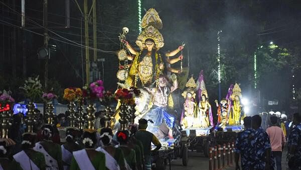 <div class="paragraphs"><p>Devotees carry an idol of Goddess Durga during a procession, ahead of the Durga Puja Carnival 2024.</p></div>