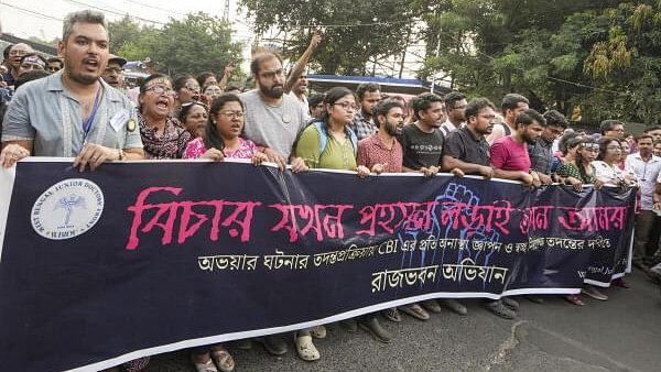 <div class="paragraphs"><p>Junior doctors take part in a protest march to Raj Bhavan demanding a quick and transparent probe into the alleged sexual assault and murder of a trainee doctor, in Kolkata.&nbsp;</p></div>