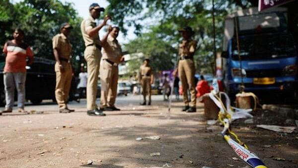 <div class="paragraphs"><p>Police officers stand at the crime scene next to markings of the gunshots where Nationalist Congress Party (NCP) politician Baba Siddique was shot dead in Mumbai.</p></div>