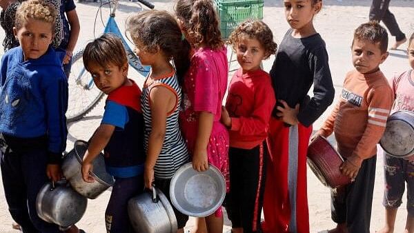 <div class="paragraphs"><p>Palestinian children queue to receive food cooked by a charity kitchen, amid the Israel-Hamas conflict, in Khan Younis in the southern Gaza Strip, October 16, 2024.</p></div>