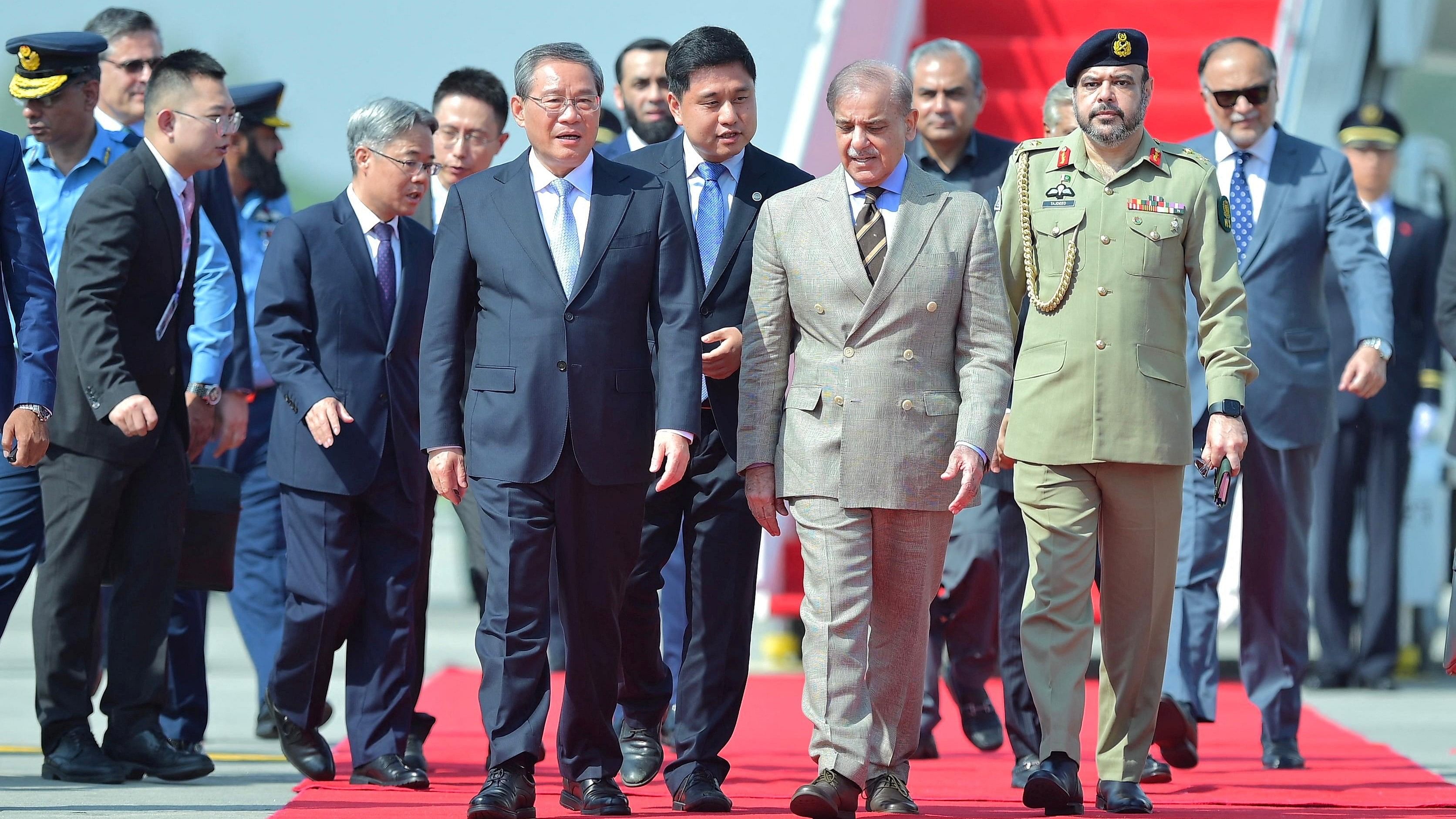 <div class="paragraphs"><p>Pakistan's Prime Minister Shehbaz Sharif walks with Chinese Premier Li Qiang, upon his arrival in Islamabad</p></div>