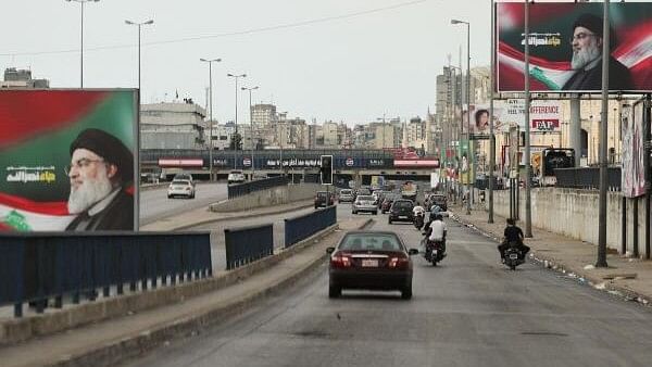 <div class="paragraphs"><p>Cars drive past billboards depicting late leader of Lebanon's Hezbollah, Hassan Nasrallah, amid the ongoing hostilities between Hezbollah and Israel, in Beirut Lebanon October 16, 2024.</p></div>