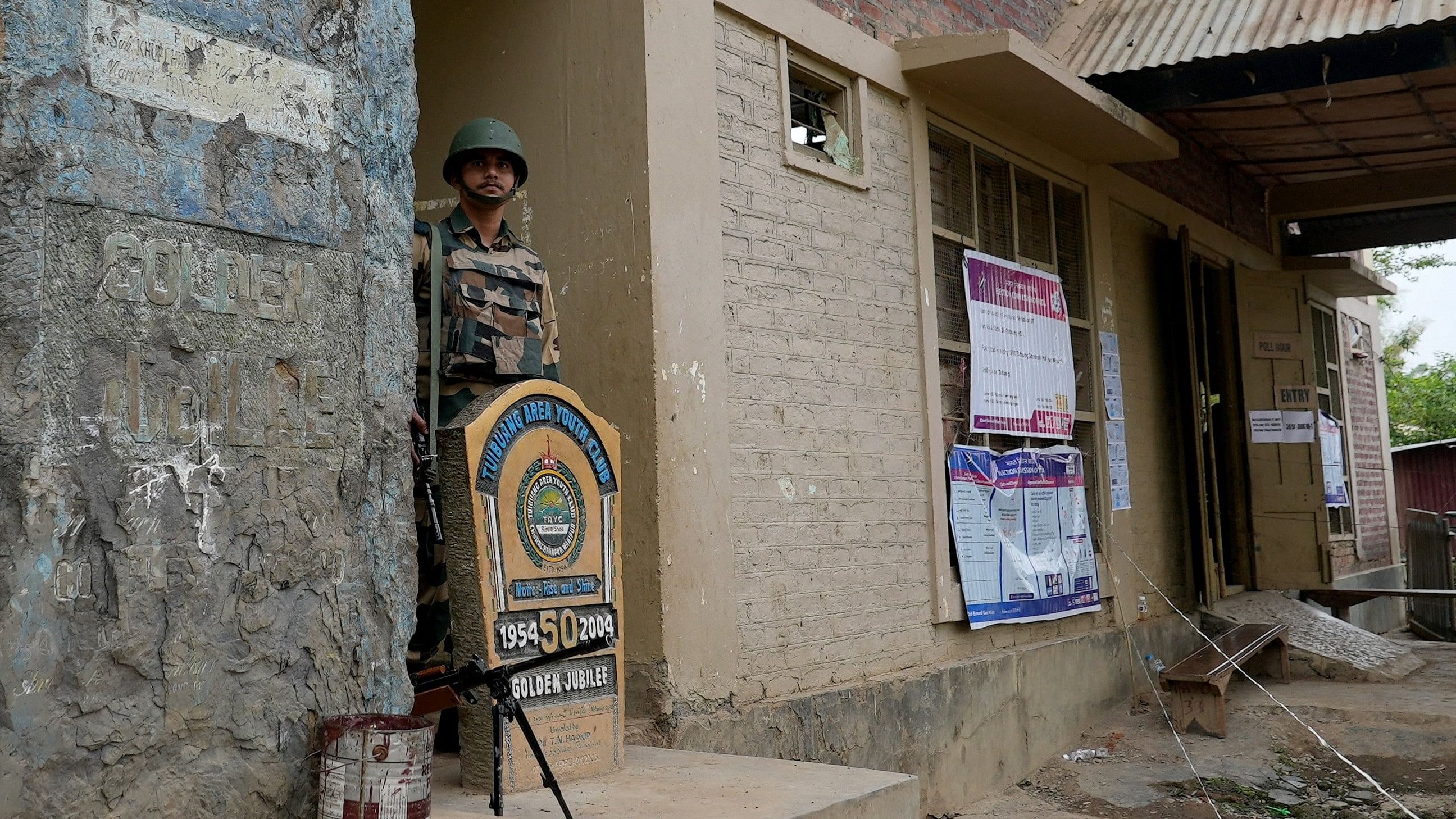 <div class="paragraphs"><p>A security force personnel stands guard at a polling station inside a relief camp during the first phase of the general election, in Churachandpur, Manipur, April 19, 2024. </p></div>