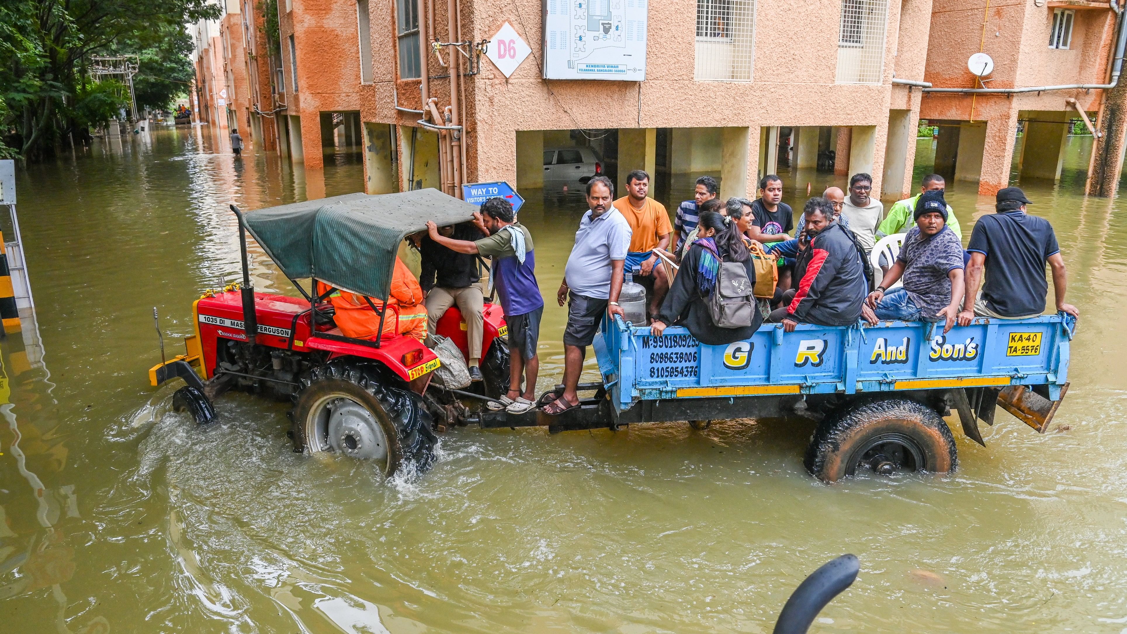 <div class="paragraphs"><p>Tractors ferry residents in and out of Kendriya Vihar Apartment near Kogilu Cross in Yelahanka. </p></div>