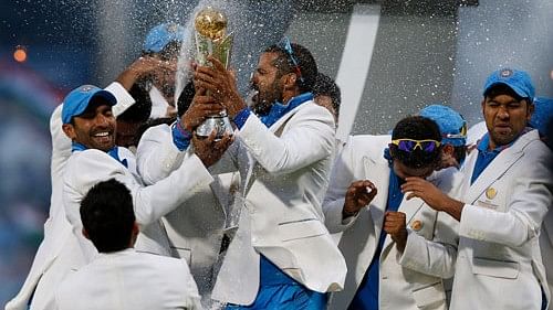 <div class="paragraphs"><p>India's players celebrate with the trophy after their win against England at the end of their ICC Champions Trophy final cricket match at Edgbaston cricket ground in Birmingham, England, Sunday, June 23, 2013. </p></div>