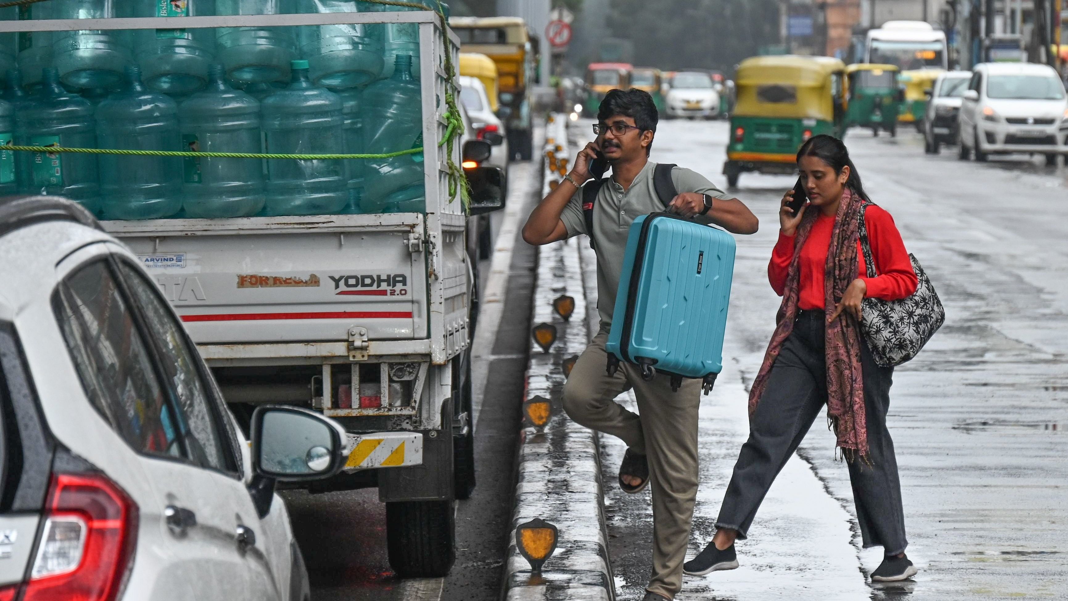 <div class="paragraphs"><p>Passengers wait for transport on MG Road on Wednesday</p></div>