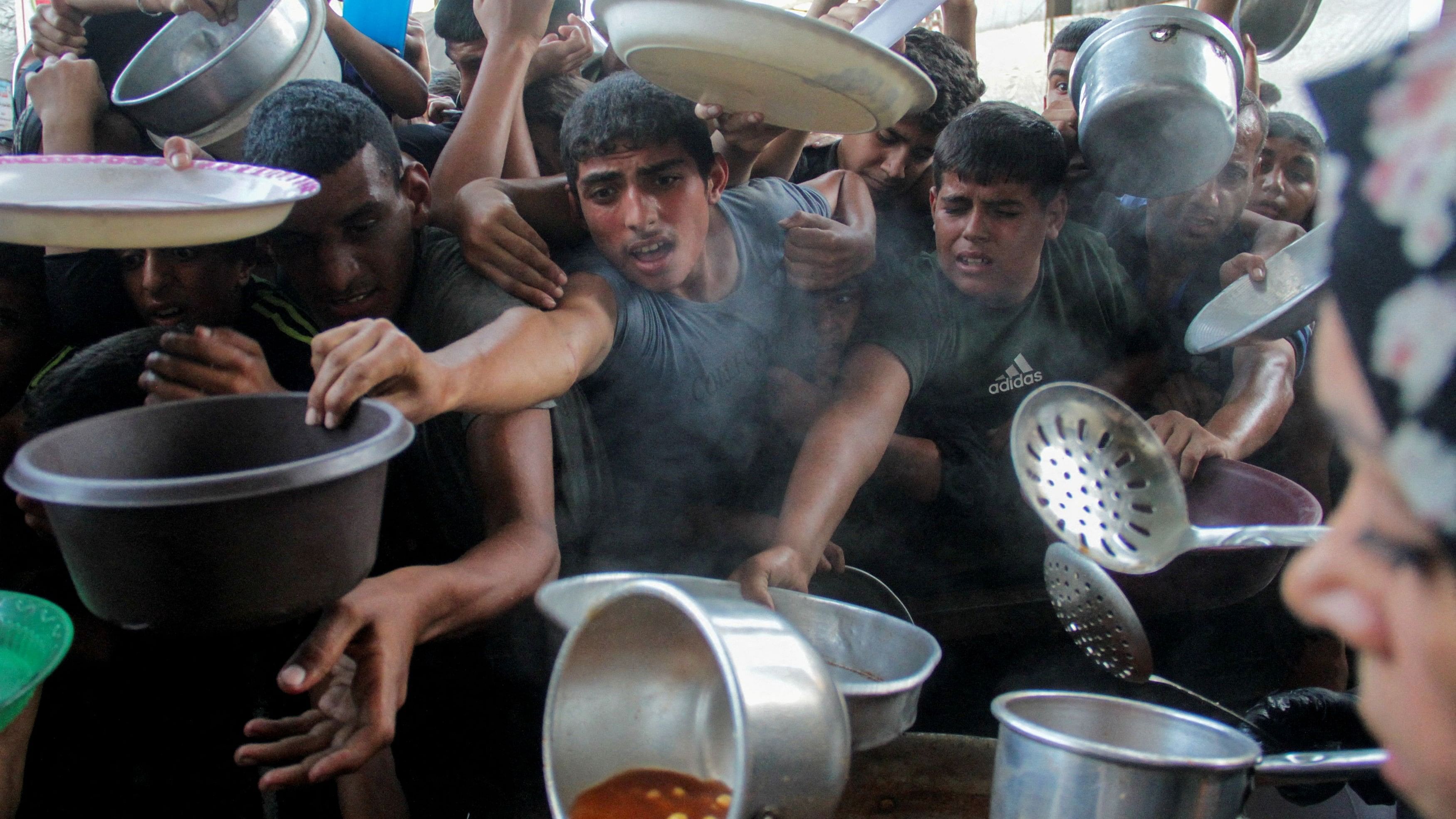 <div class="paragraphs"><p>Palestinians gather to receive food cooked by a charity kitchen, amid the Israel-Hamas conflict, in the northern Gaza Strip, September 11, 2024.</p></div>