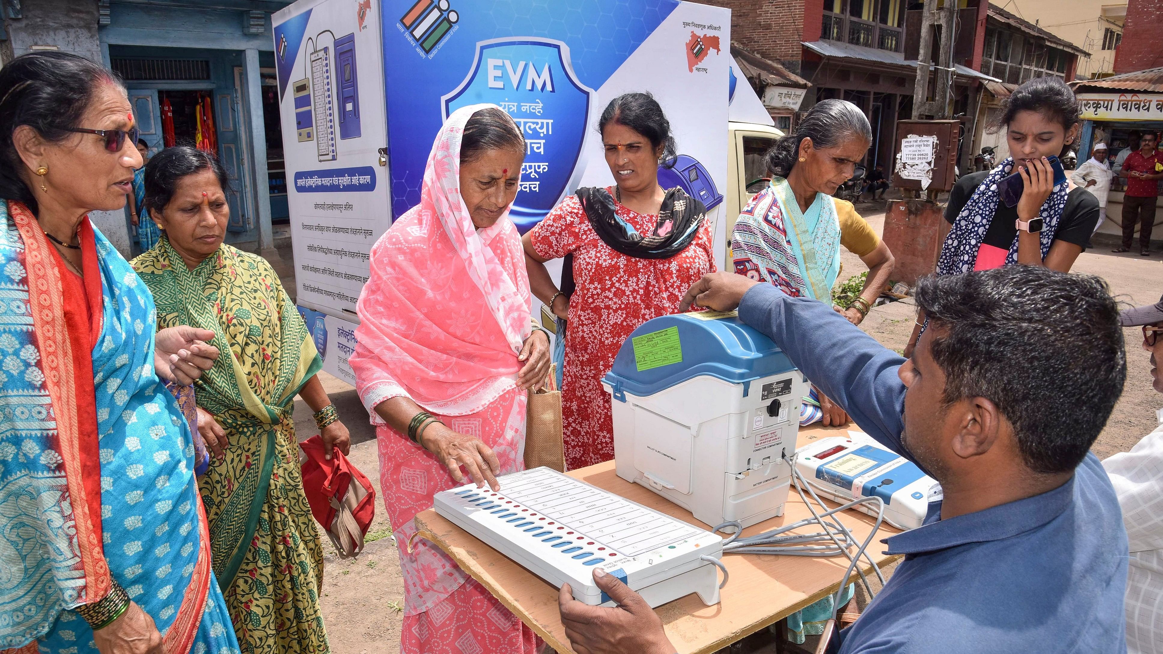 <div class="paragraphs"><p>Electoral officials demonstrate the usage of an Electronic Voting Machine (EVM) and Voter-Verified Paper Audit Trail (VVPAT) to locals during a voter awareness programme ahead of Assembly elections.</p></div>