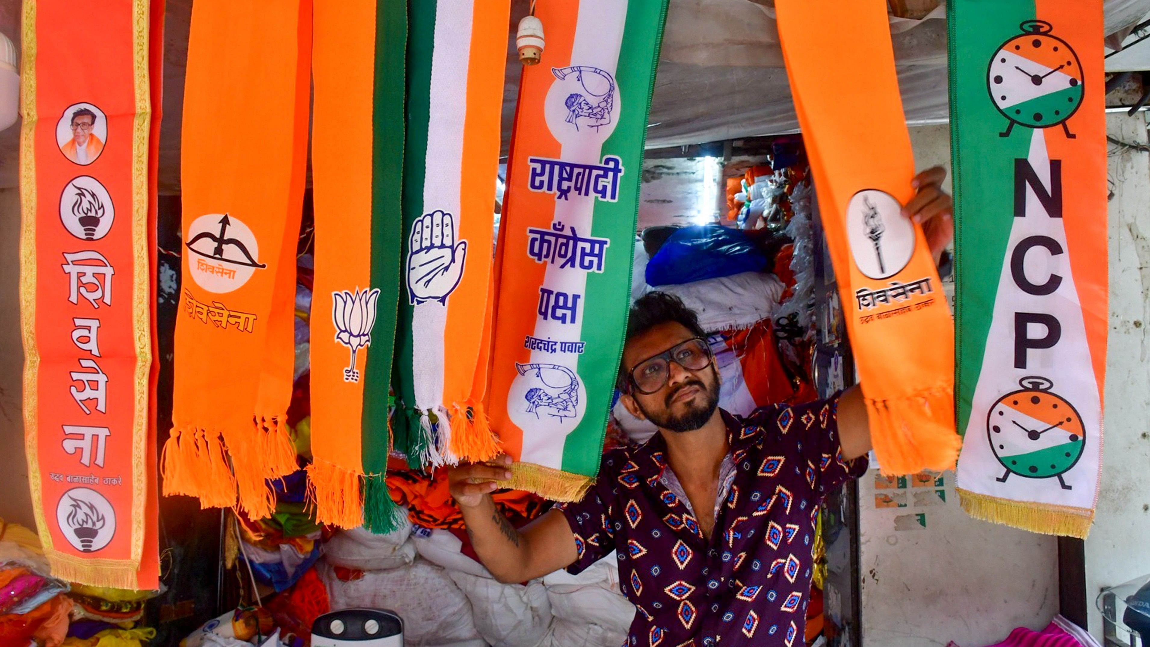 <div class="paragraphs"><p>A man arranges scarves of political parties at a shop, ahead of Maharashtra Assembly elections, in Mumbai.</p></div>