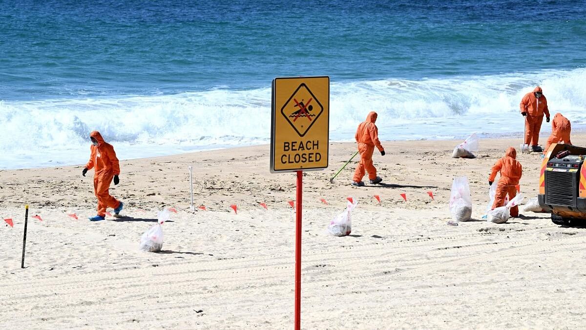 <div class="paragraphs"><p>Workers in protective clothing clean up unknown debris washed up on Coogee Beach, Sydney, Australia October 17, 2024.</p></div>